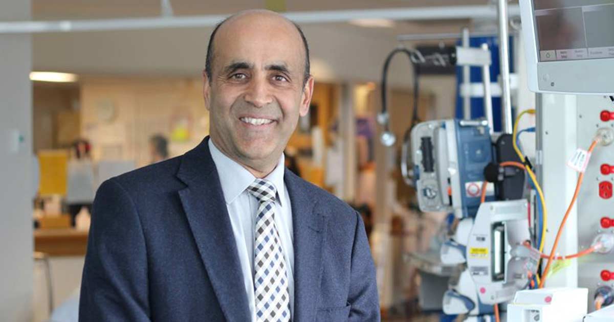 The Wesley Hospital staff member assisting older lady walking on crutches.