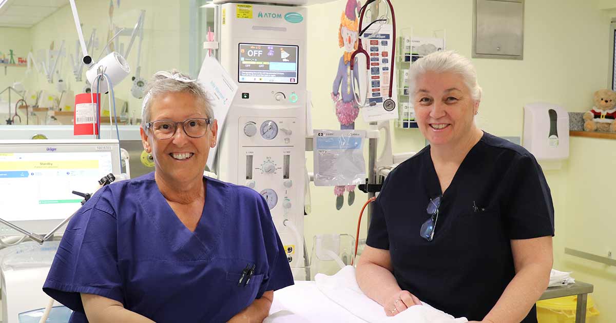 The Wesley Hospital staff member assisting older lady walking on crutches.