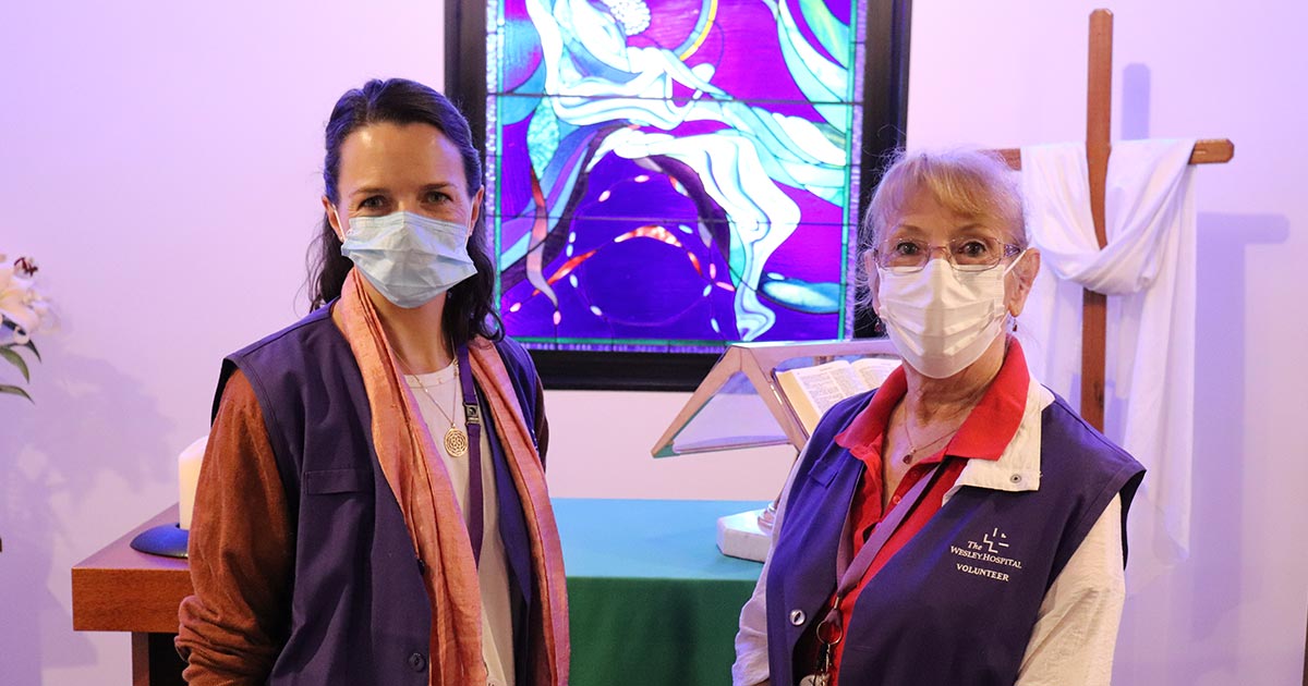 The Wesley Hospital volunteer End of Life Compassionate Companions standing in the chapel, wearing masks looking at camera