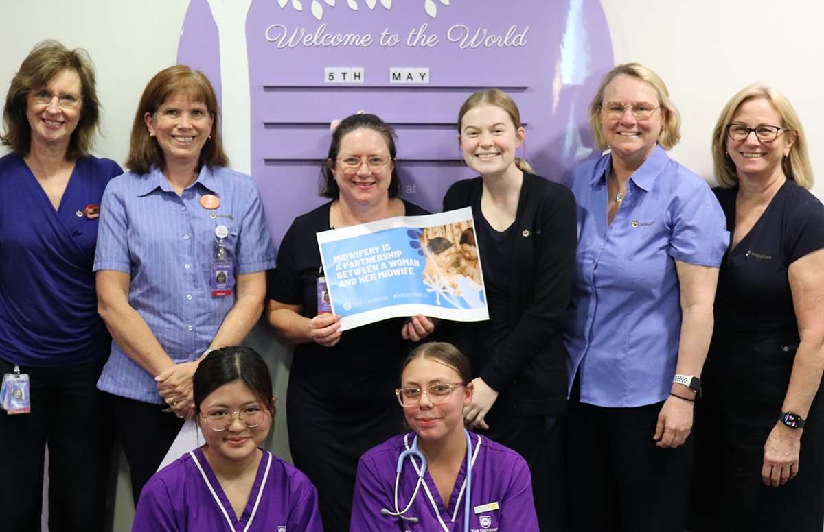 International day of the Midwife 2023 banner Wesley hospital Midwives standing in front of wall art
