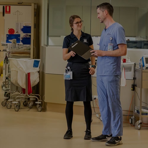 Be focused – A young Graduate Nurse Program participant talks with a doctor in a Wesley Hospital corridor.