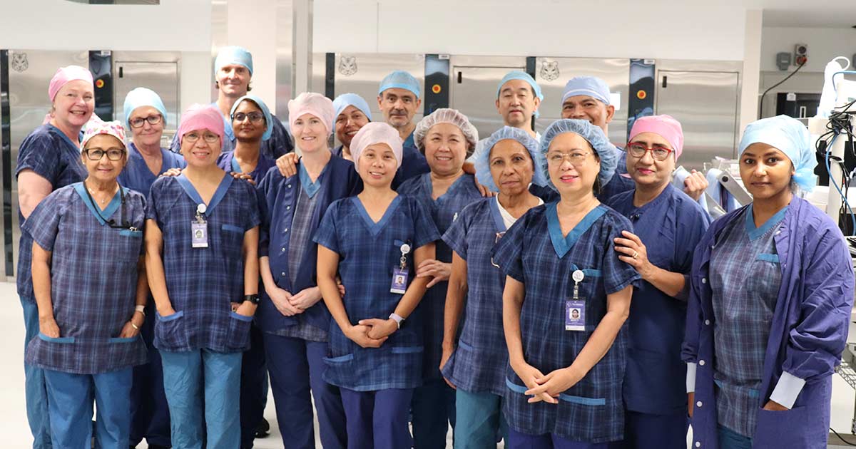 The Wesley Hospital's Central Sterilising Services Department (CSSD) team standing together dressed in scrubs.